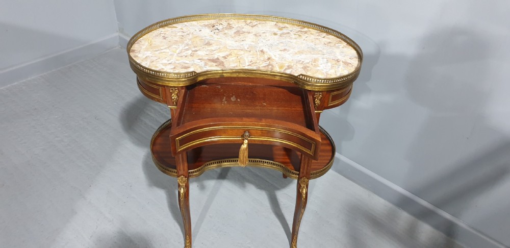 A French kidney-shaped mahogany side table featuring a marble top, upper brass gallery, lower shelf, and gilt bronze mounts. View VII