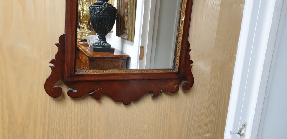 A Georgian mahogany fretwork wall mirror featuring a scrolled frame, a gilded bird motif at the top crest, and a gilded inner border. View III