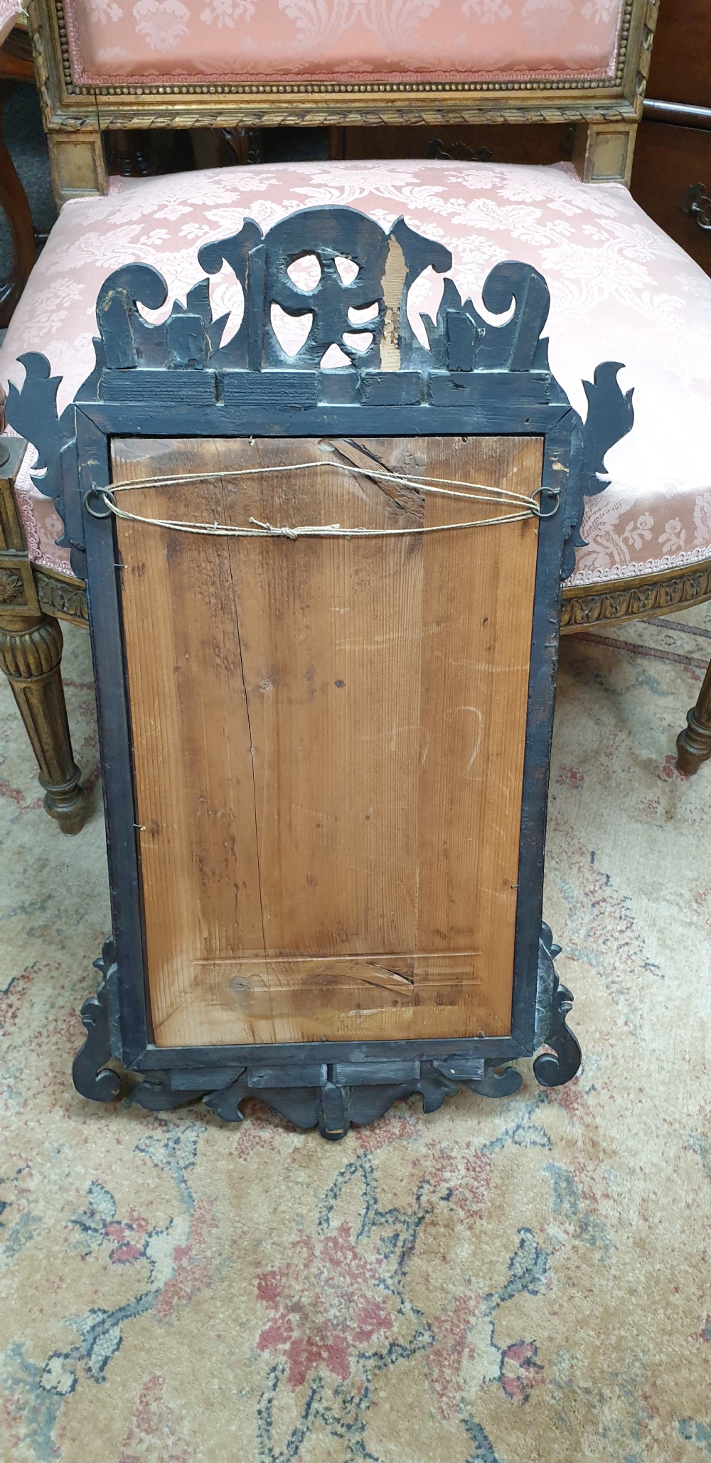 A Georgian mahogany fretwork wall mirror featuring a scrolled frame, a gilded bird motif at the top crest, and a gilded inner border. View VII