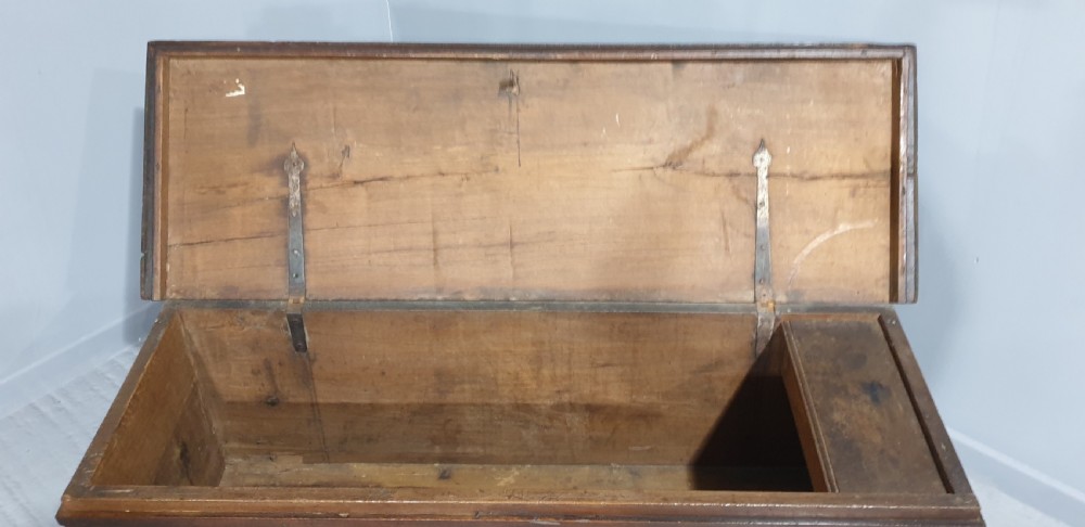A dark brown carved wood Italian cassone coffer featuring two foliate relief panels and carved lion paw feet. View VII