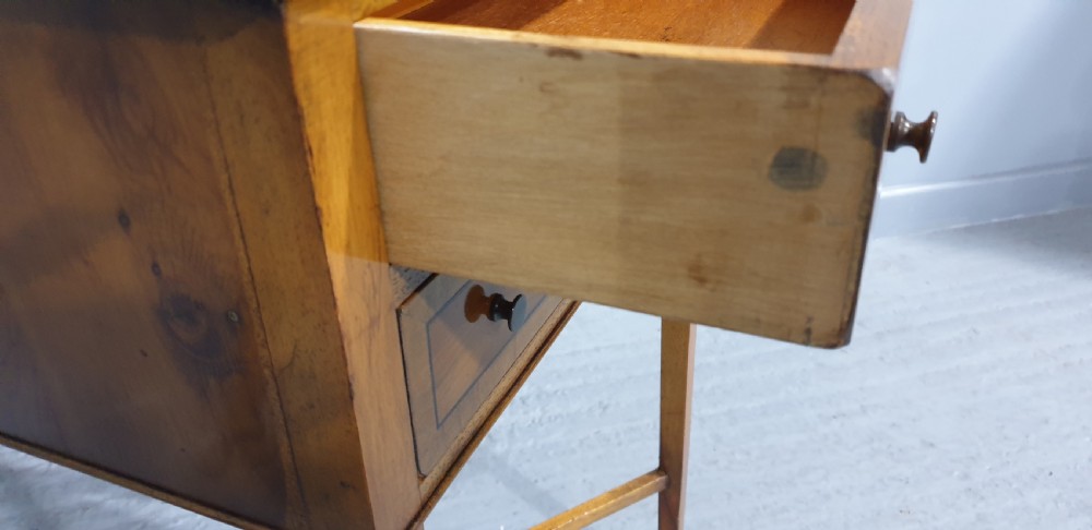 A tall yew wood side table featuring two drawers adorned with oval floral marquetry inlays, slim square legs, and an X-frame stretcher base. View VIII