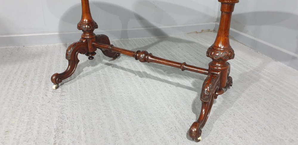 A Victorian kidney-shaped writing desk crafted from burr walnut with a green leather inset top and carved turned legs joined by a stretcher. View III