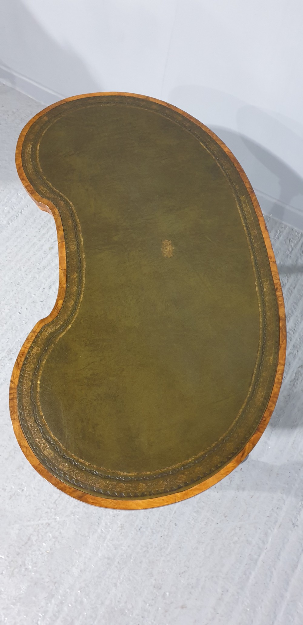 A Victorian kidney-shaped writing desk crafted from burr walnut with a green leather inset top and carved turned legs joined by a stretcher. View VIII