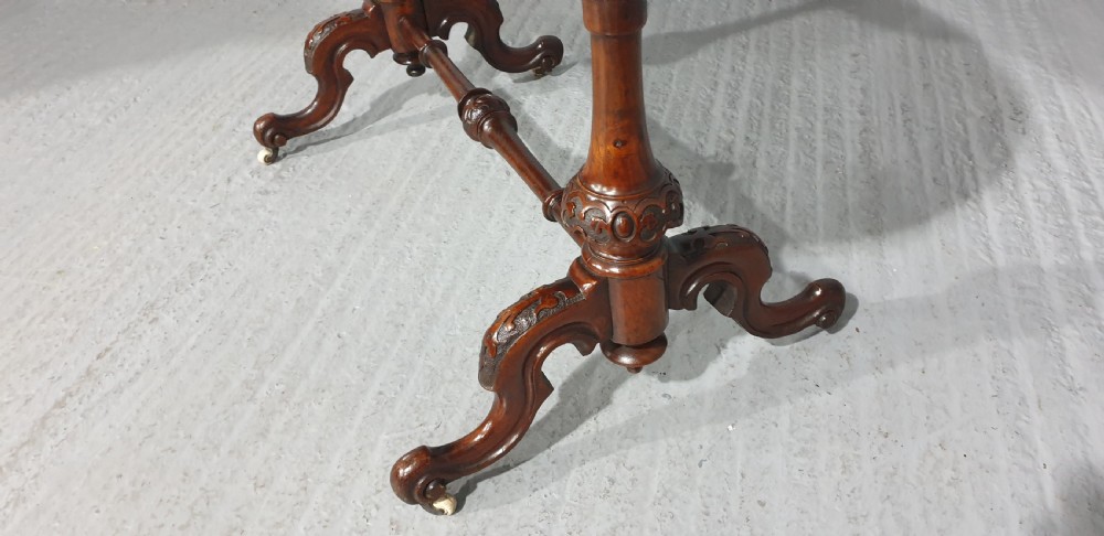 A Victorian kidney-shaped writing desk crafted from burr walnut with a green leather inset top and carved turned legs joined by a stretcher. View XI