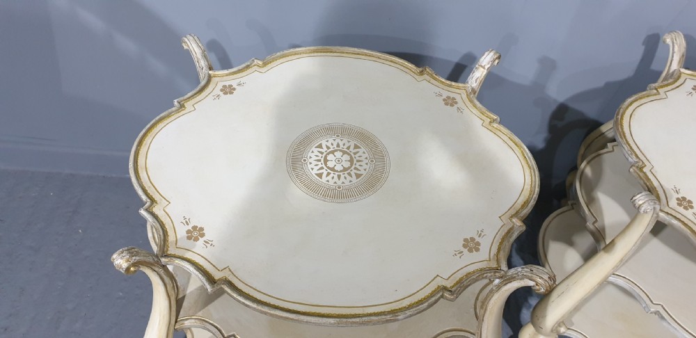 A pair of cream painted three-tier occasional lamp tables with cabriole legs and painted floral medallion tops. View VI