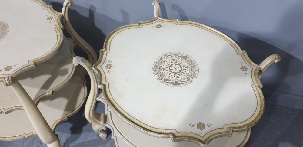 A pair of cream painted three-tier occasional lamp tables with cabriole legs and painted floral medallion tops. View VII