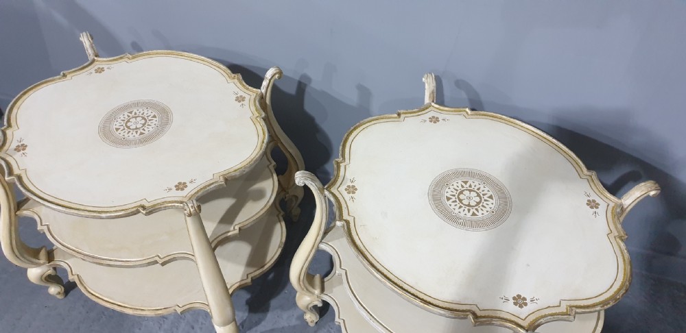 A pair of cream painted three-tier occasional lamp tables with cabriole legs and painted floral medallion tops. View VIII