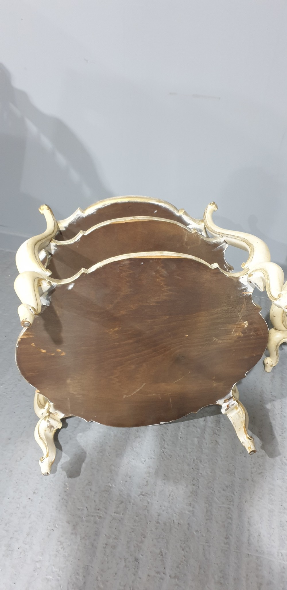 A pair of cream painted three-tier occasional lamp tables with cabriole legs and painted floral medallion tops. View IX