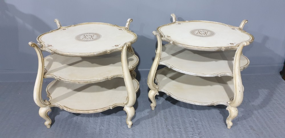 A pair of cream painted three-tier occasional lamp tables with cabriole legs and painted floral medallion tops. View XI
