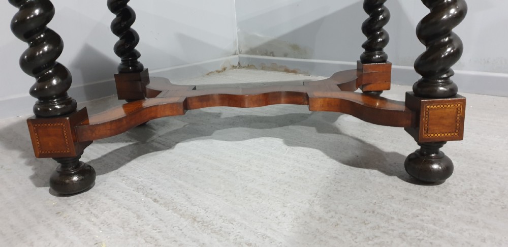An antique laburnum and walnut oyster veneered centre table featuring barley twist legs, a star inlay on the drawer front, a shaped stretcher, and ball feet. View III