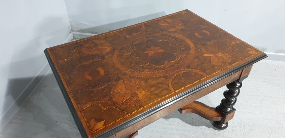 An antique laburnum and walnut oyster veneered centre table featuring barley twist legs, a star inlay on the drawer front, a shaped stretcher, and ball feet. View VI