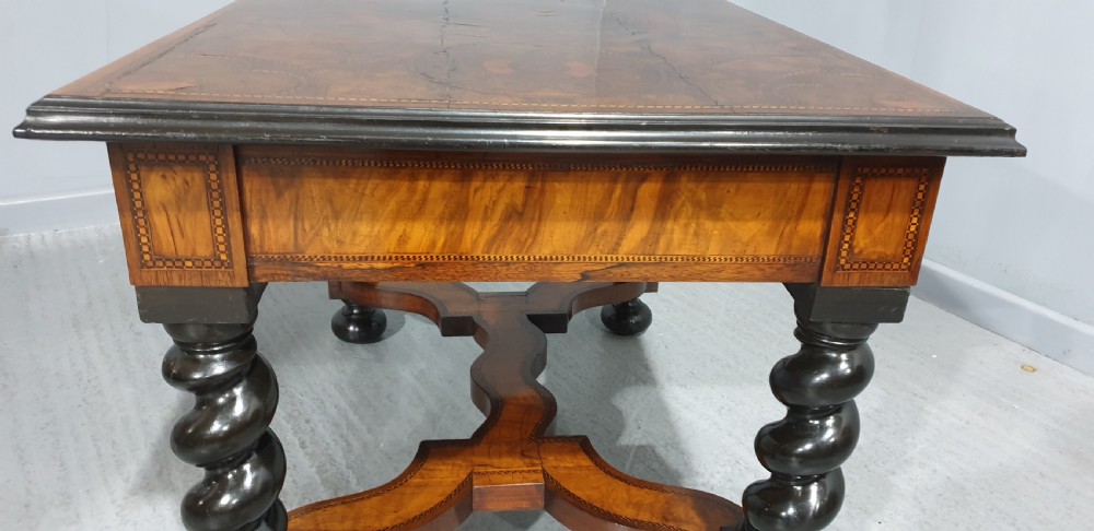 An antique laburnum and walnut oyster veneered centre table featuring barley twist legs, a star inlay on the drawer front, a shaped stretcher, and ball feet. View VIII