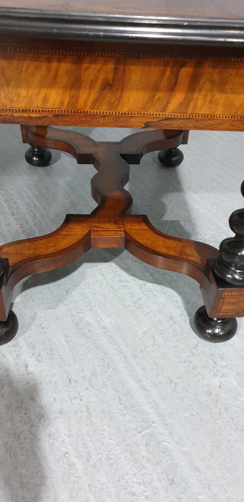 An antique laburnum and walnut oyster veneered centre table featuring barley twist legs, a star inlay on the drawer front, a shaped stretcher, and ball feet. View IX