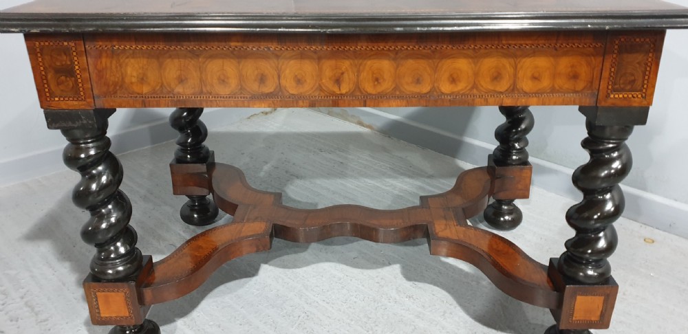 An antique laburnum and walnut oyster veneered centre table featuring barley twist legs, a star inlay on the drawer front, a shaped stretcher, and ball feet. View XVI
