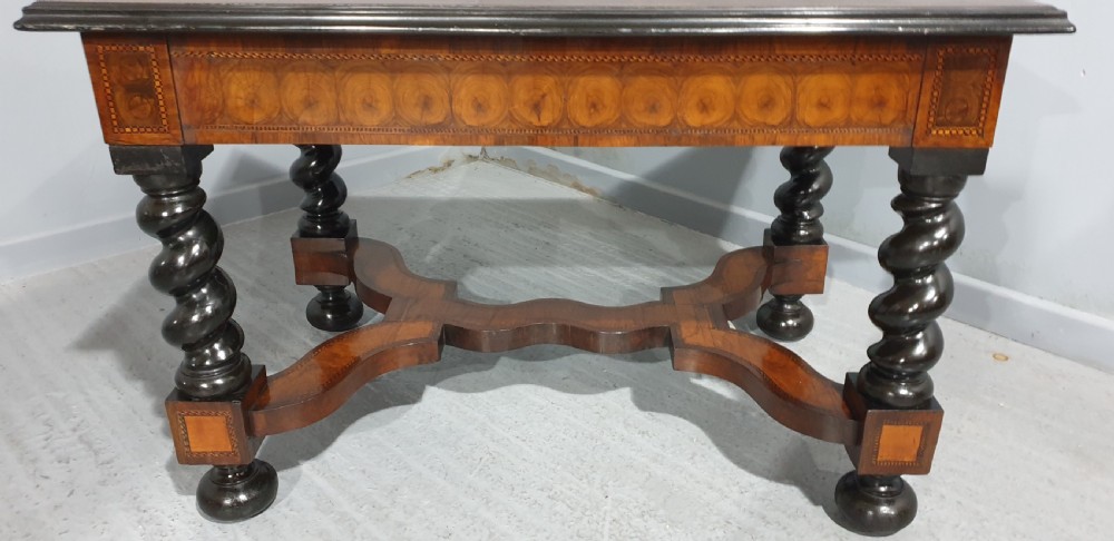 An antique laburnum and walnut oyster veneered centre table featuring barley twist legs, a star inlay on the drawer front, a shaped stretcher, and ball feet. View XVII