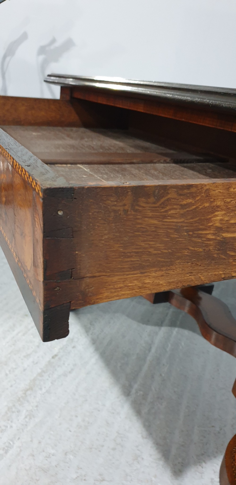An antique laburnum and walnut oyster veneered centre table featuring barley twist legs, a star inlay on the drawer front, a shaped stretcher, and ball feet. View XIX