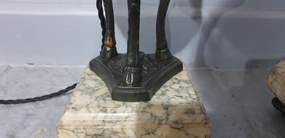 A pair of French spelter table lamps crafted in the form of classical urns set on square veined marble bases. View VI