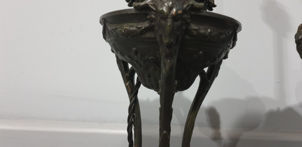 A pair of French spelter table lamps crafted in the form of classical urns set on square veined marble bases. View VII