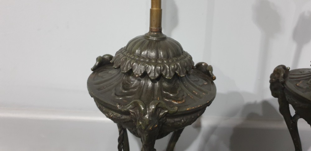 A pair of French spelter table lamps crafted in the form of classical urns set on square veined marble bases. View VIII