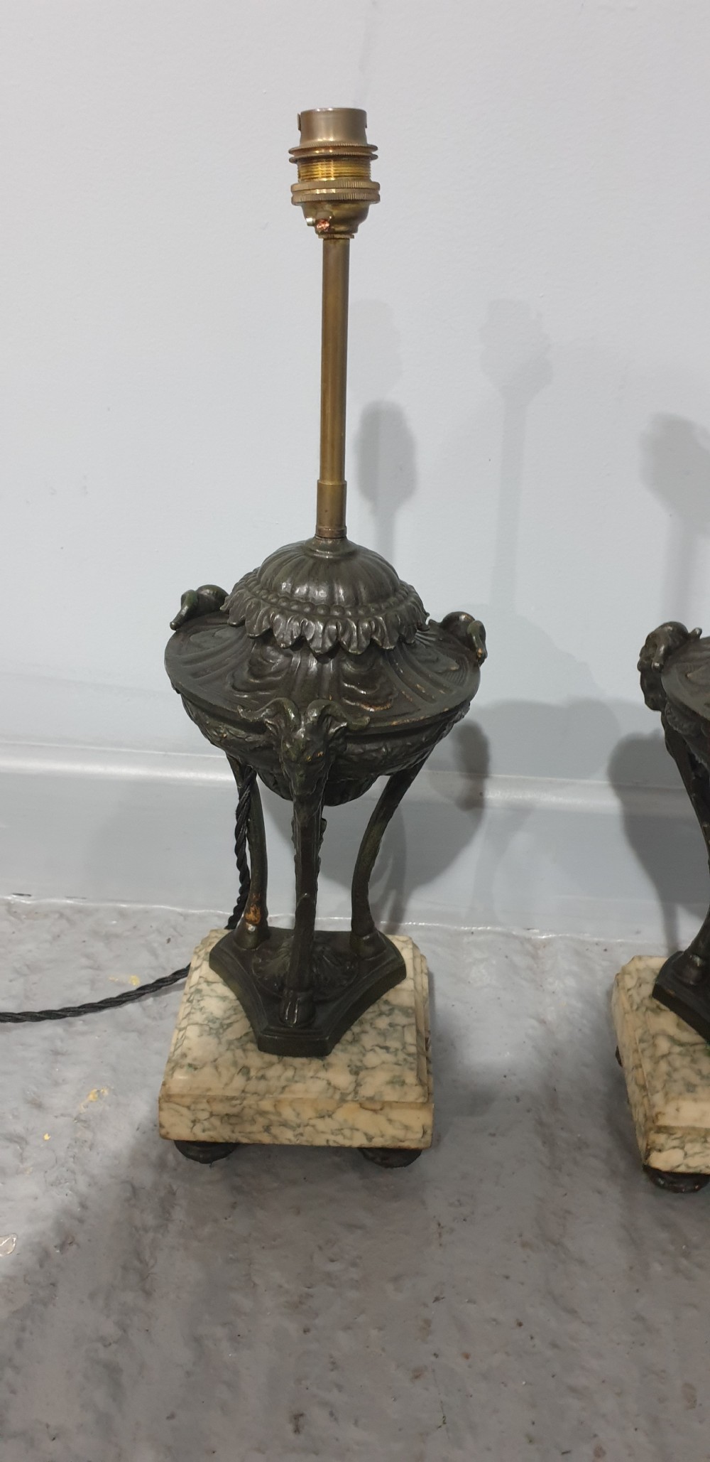 A pair of French spelter table lamps crafted in the form of classical urns set on square veined marble bases. View IX