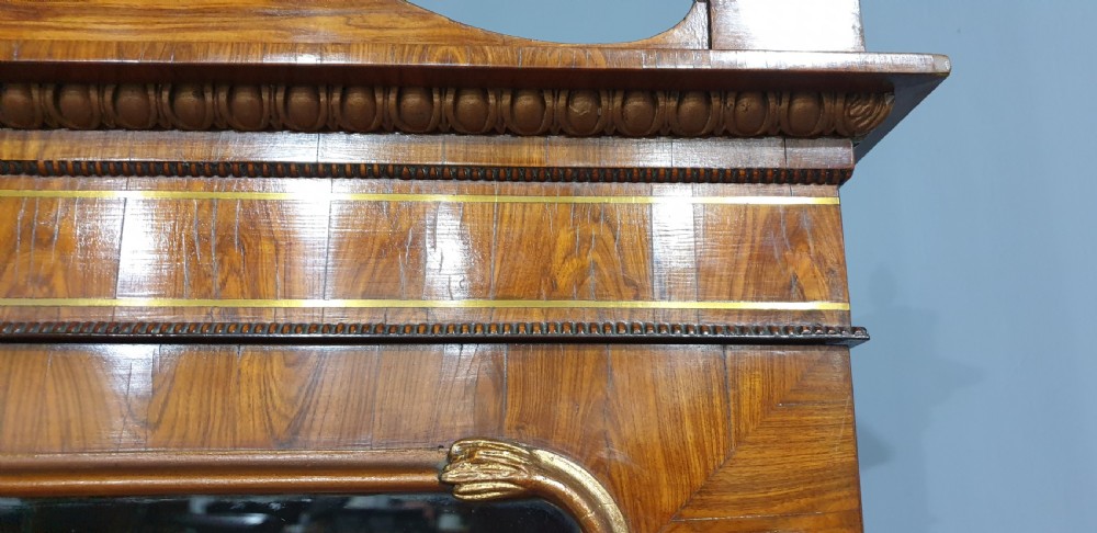 A Regency rosewood bureau bookcase featuring a scrolled pediment with brass finials, glazed upper display doors, a roll-top cylinder writing section with brass inlay, and a twin-door lower cupboard. View XVI