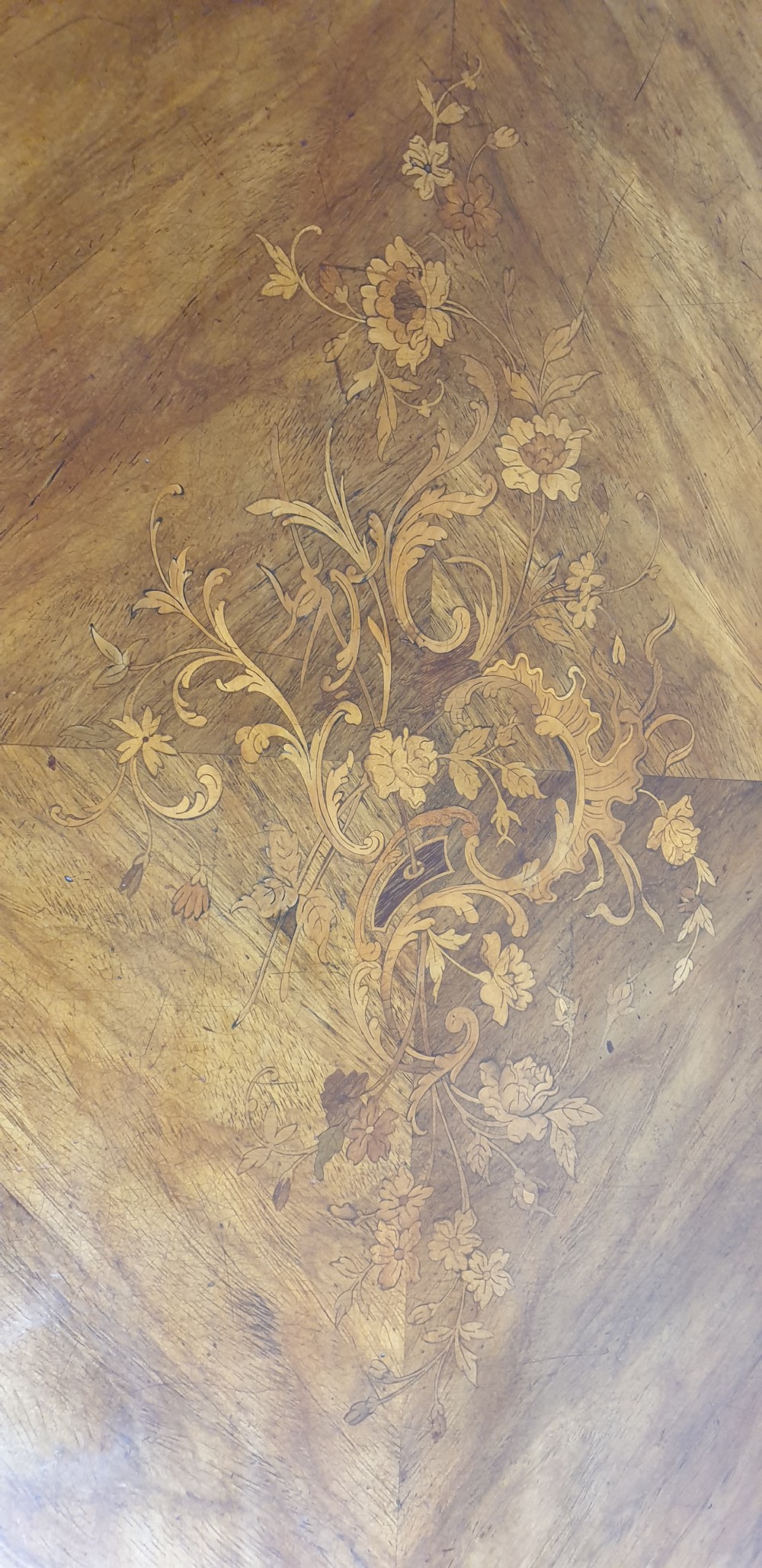 A French Louis XV style bureau plat decorated with floral marquetry inlay, curved cabriole legs, and ornate gilt bronze mounts. View VIII