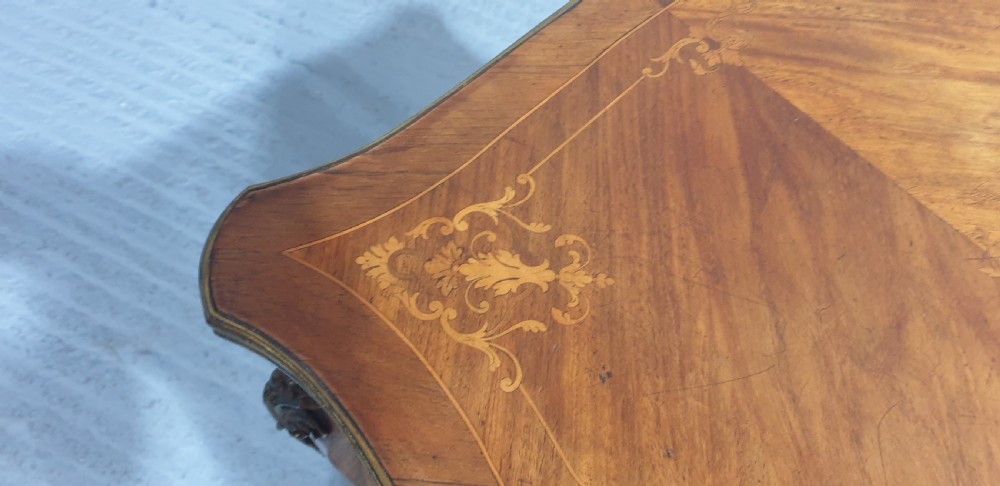A French Louis XV style bureau plat decorated with floral marquetry inlay, curved cabriole legs, and ornate gilt bronze mounts. View IX