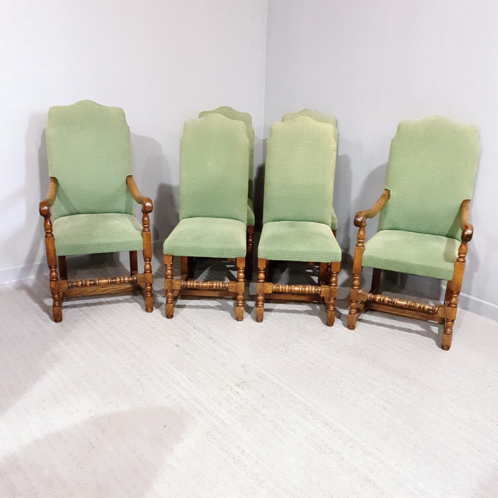 A set of six oak dining chairs with green textured upholstery, including two open-arm carvers and four side chairs with turned legs and stretchers. View IV