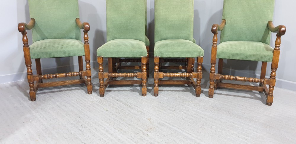 A set of six oak dining chairs with green textured upholstery, including two open-arm carvers and four side chairs with turned legs and stretchers. View VI