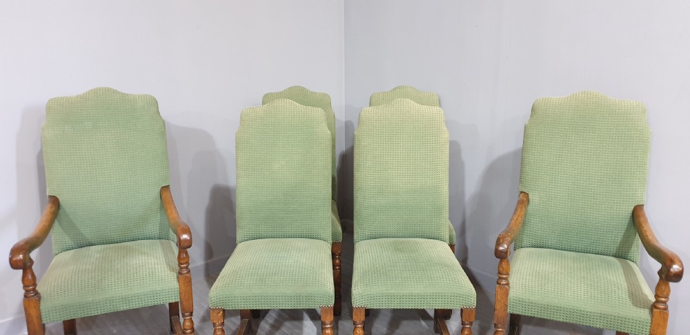 A set of six oak dining chairs with green textured upholstery, including two open-arm carvers and four side chairs with turned legs and stretchers. View VII