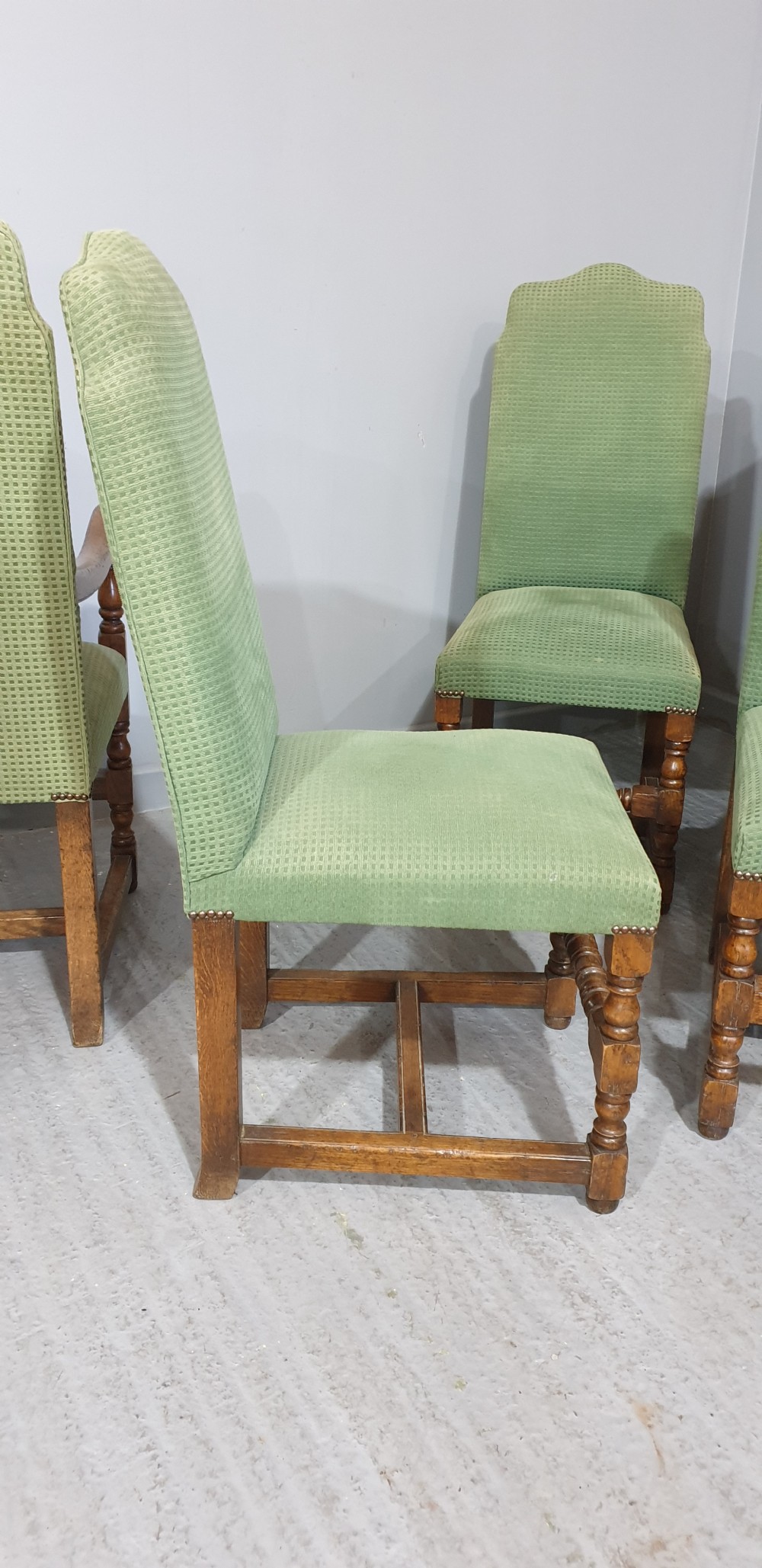 A set of six oak dining chairs with green textured upholstery, including two open-arm carvers and four side chairs with turned legs and stretchers. View XII