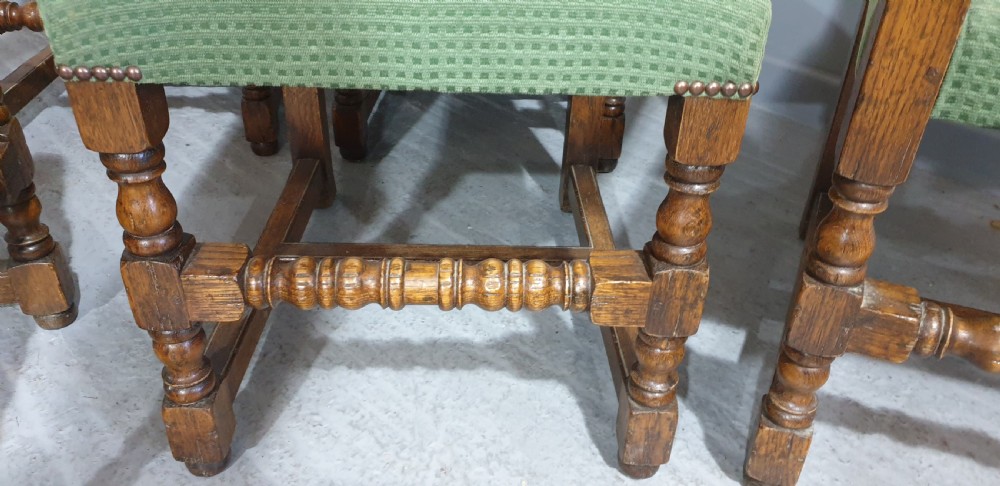 A set of six oak dining chairs with green textured upholstery, including two open-arm carvers and four side chairs with turned legs and stretchers. View XIV