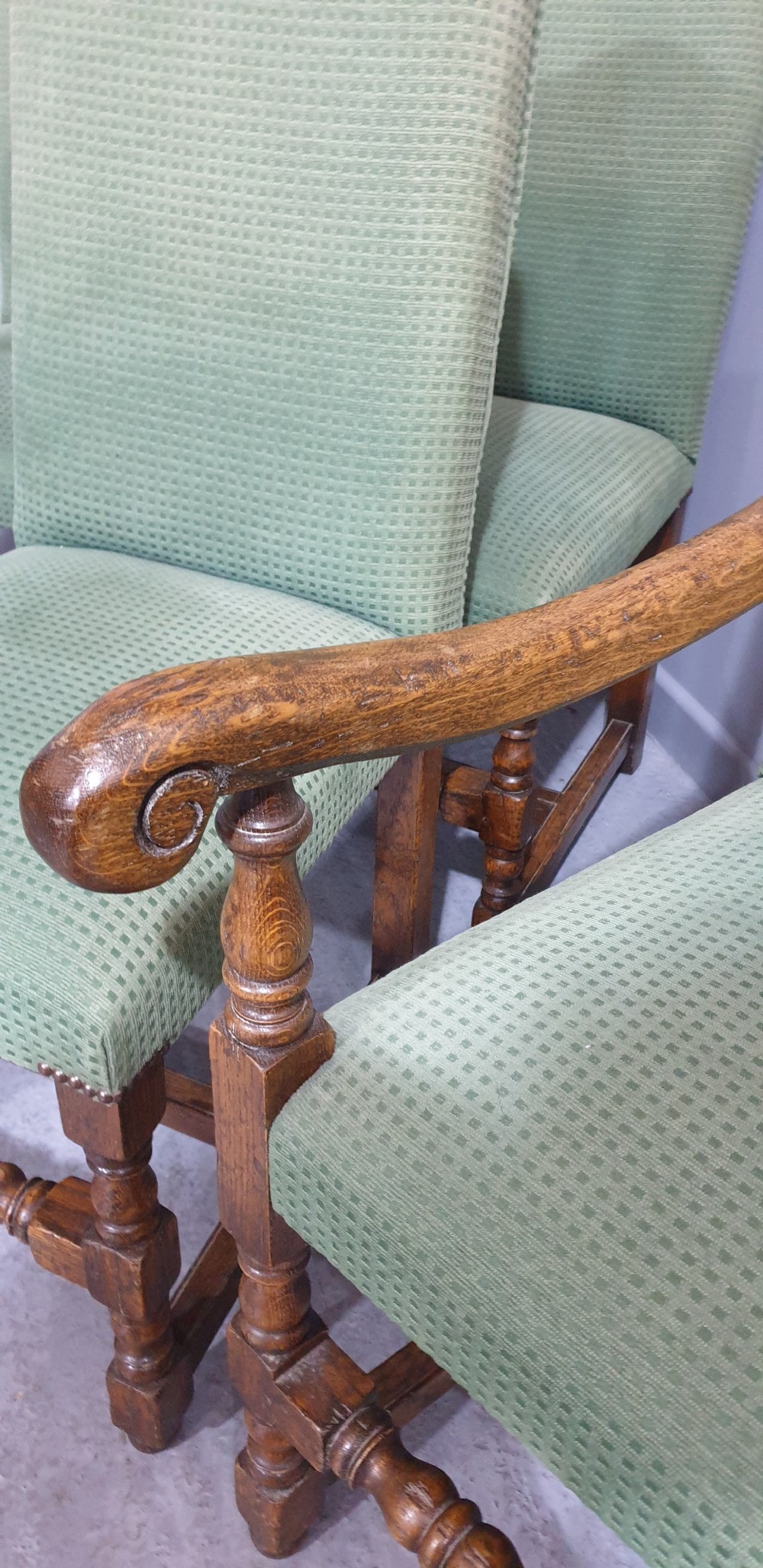 A set of six oak dining chairs with green textured upholstery, including two open-arm carvers and four side chairs with turned legs and stretchers. View XV