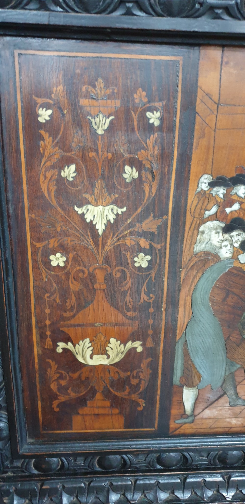 A heavily carved dark walnut Italian hall bench featuring a high backrest with intricate pictorial wood marquetry, winged griffin cresting, and lion paw feet. View IX