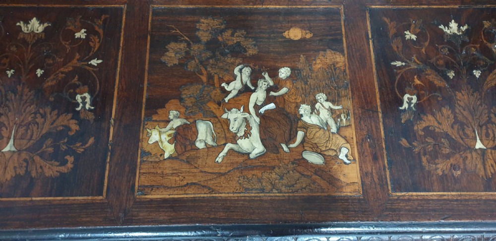 A heavily carved dark walnut Italian hall bench featuring a high backrest with intricate pictorial wood marquetry, winged griffin cresting, and lion paw feet. View XI