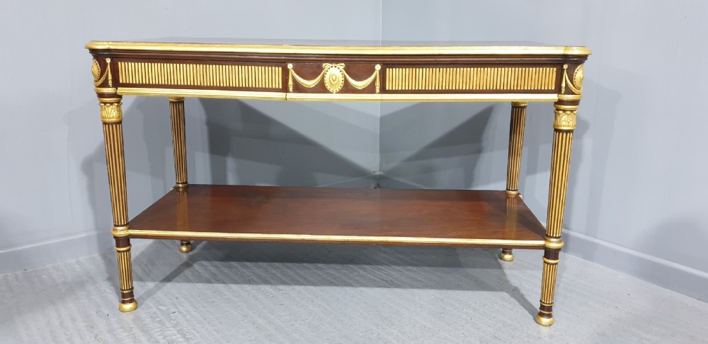 A dark mahogany rectangular console table featuring giltwood fluted legs, a lower shelf, and gold carved swags along the front apron. View V