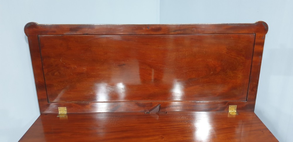 A dark mahogany rectangular console table featuring giltwood fluted legs, a lower shelf, and gold carved swags along the front apron. View XV