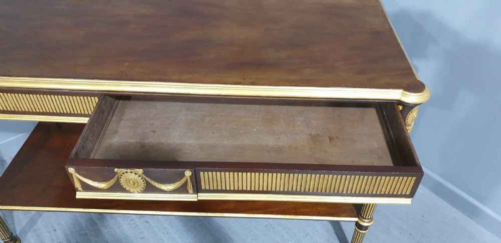 A dark mahogany rectangular console table featuring giltwood fluted legs, a lower shelf, and gold carved swags along the front apron. View XX