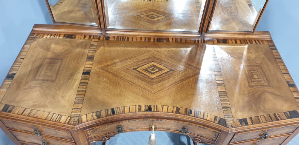 An Edwardian wooden dressing table featuring herringbone parquetry veneers, five drawers, carved legs with a curved stretcher, and an adjustable triple mirror. View III