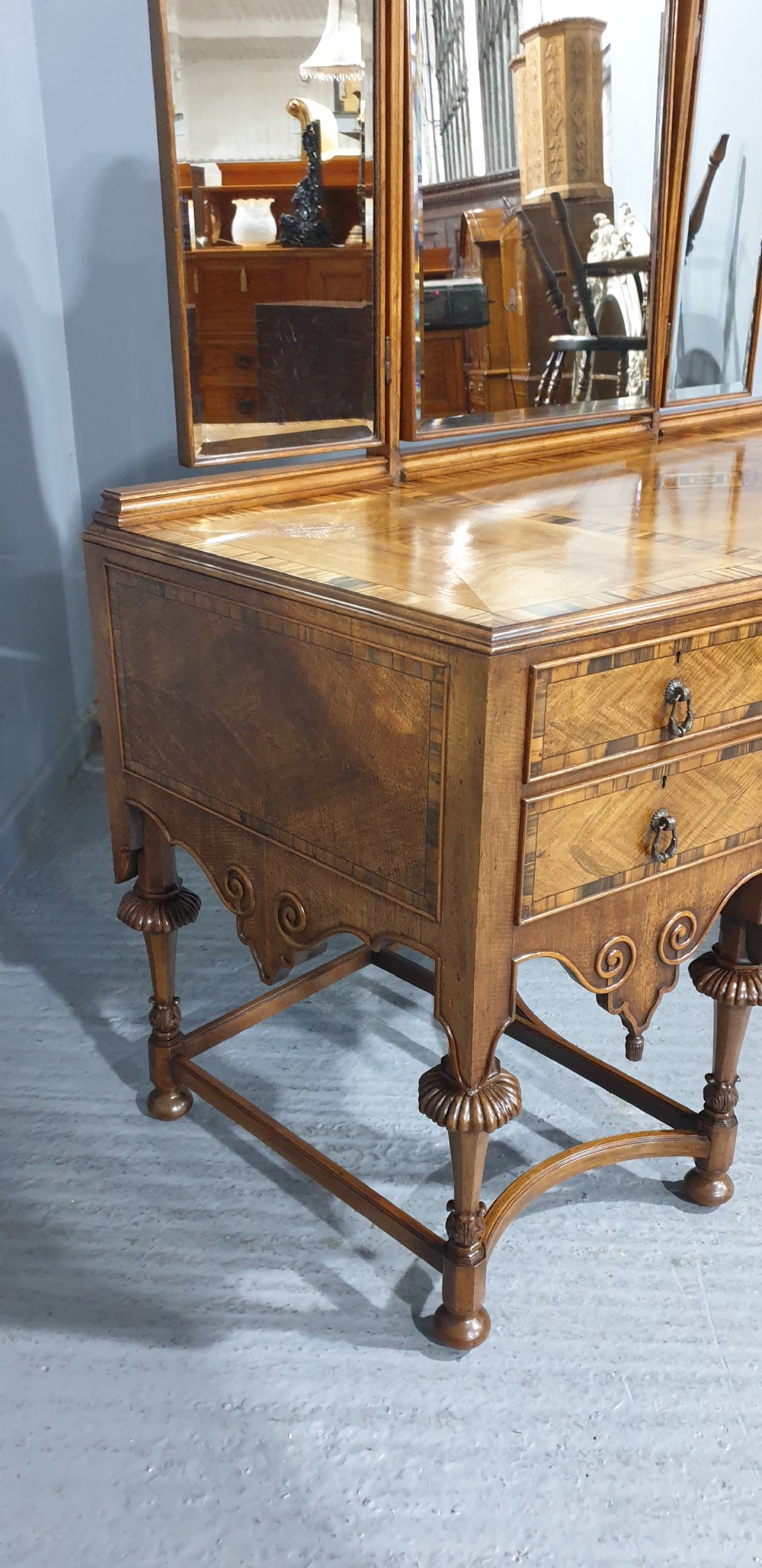 An Edwardian wooden dressing table featuring herringbone parquetry veneers, five drawers, carved legs with a curved stretcher, and an adjustable triple mirror. View XVI