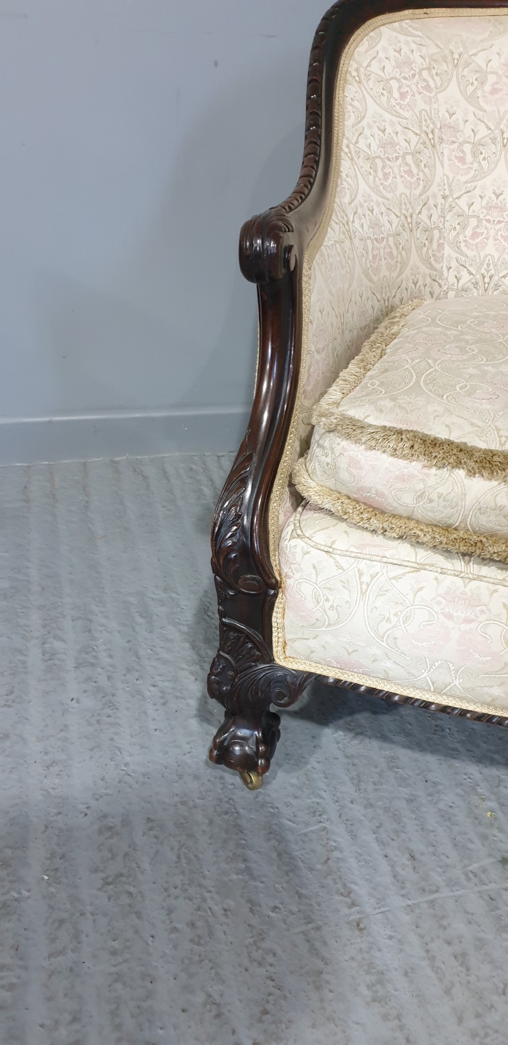 A pair of Victorian mahogany hoop-backed easy chairs upholstered in cream patterned damask fabric with carved legs on brass castors. View III