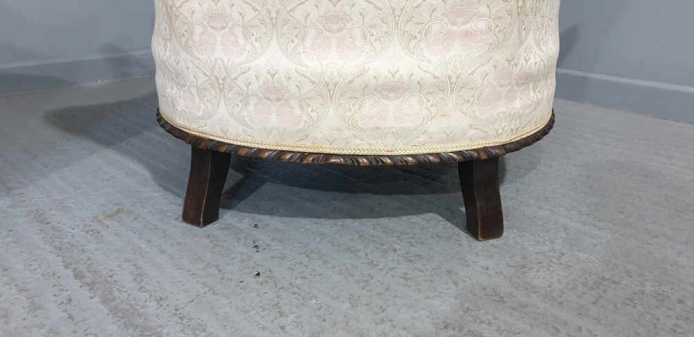 A pair of Victorian mahogany hoop-backed easy chairs upholstered in cream patterned damask fabric with carved legs on brass castors. View XII