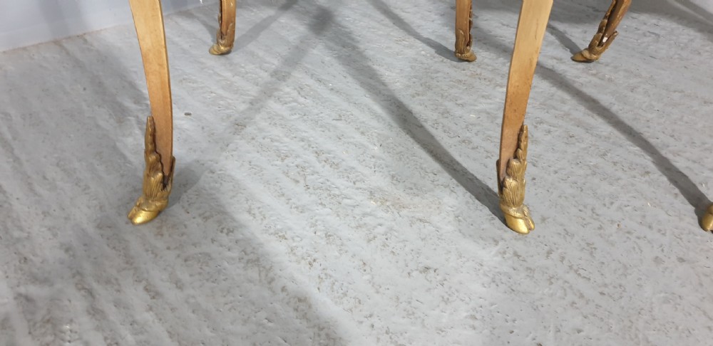 A pair of French Louis XV style tall side tables featuring cream painted cabriole legs with gilt carved embellishments and wooden tops. View IV