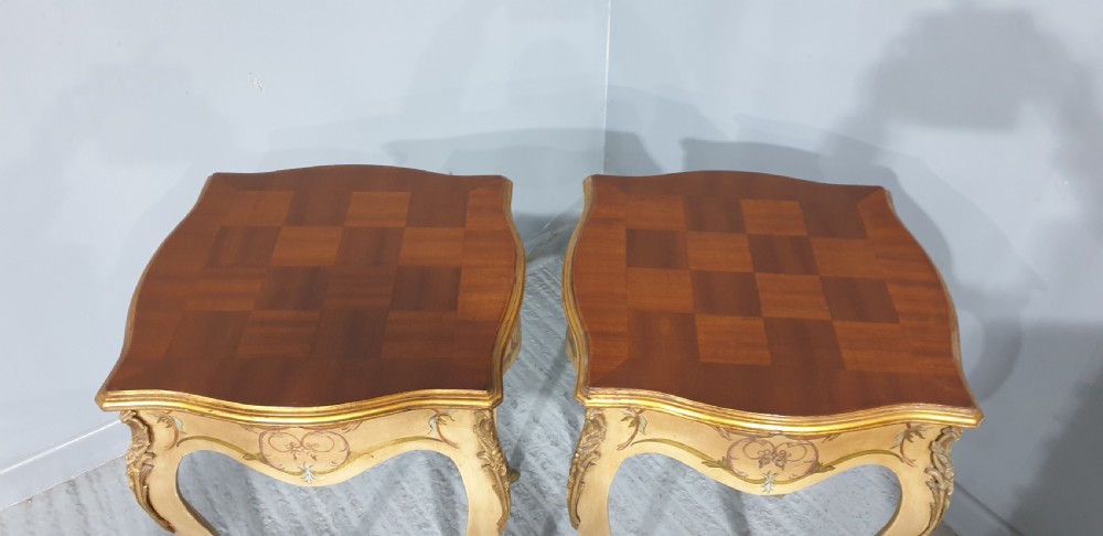 A pair of French Louis XV style tall side tables featuring cream painted cabriole legs with gilt carved embellishments and wooden tops. View V