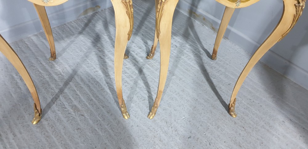 A pair of French Louis XV style tall side tables featuring cream painted cabriole legs with gilt carved embellishments and wooden tops. View IX