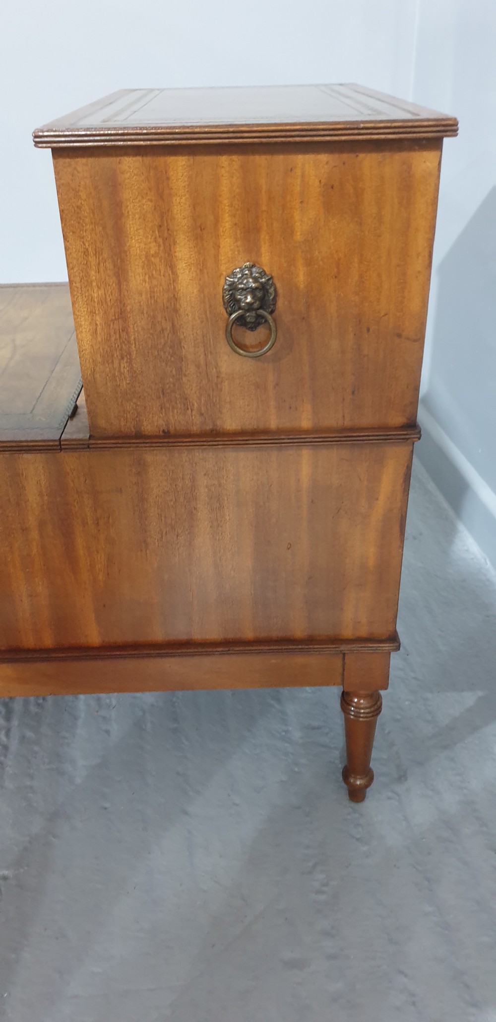 A set of three-tier Victorian mahogany library steps with leather-inset treads, turned legs, and side brass fittings. View VI