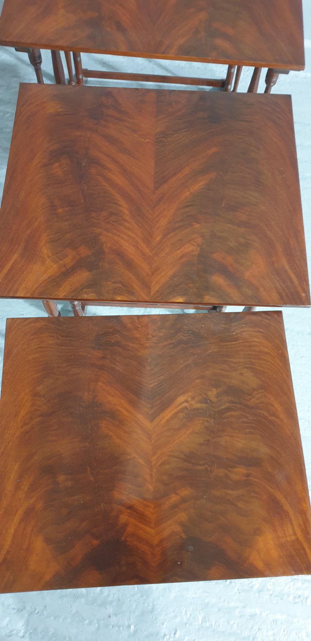 A set of four Edwardian mahogany nesting tables with rectangular tops, slender turned legs, and stretcher bases. View VI