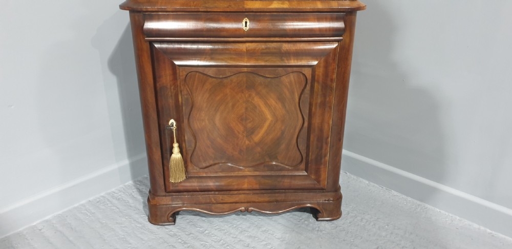 An antique Biedermeier tall warm brown veneered console cabinet featuring a fitted rectangular mirror above a single drawer and panelled cupboard base. View III