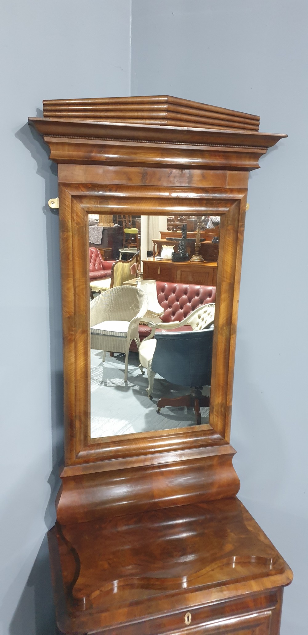 An antique Biedermeier tall warm brown veneered console cabinet featuring a fitted rectangular mirror above a single drawer and panelled cupboard base. View VII
