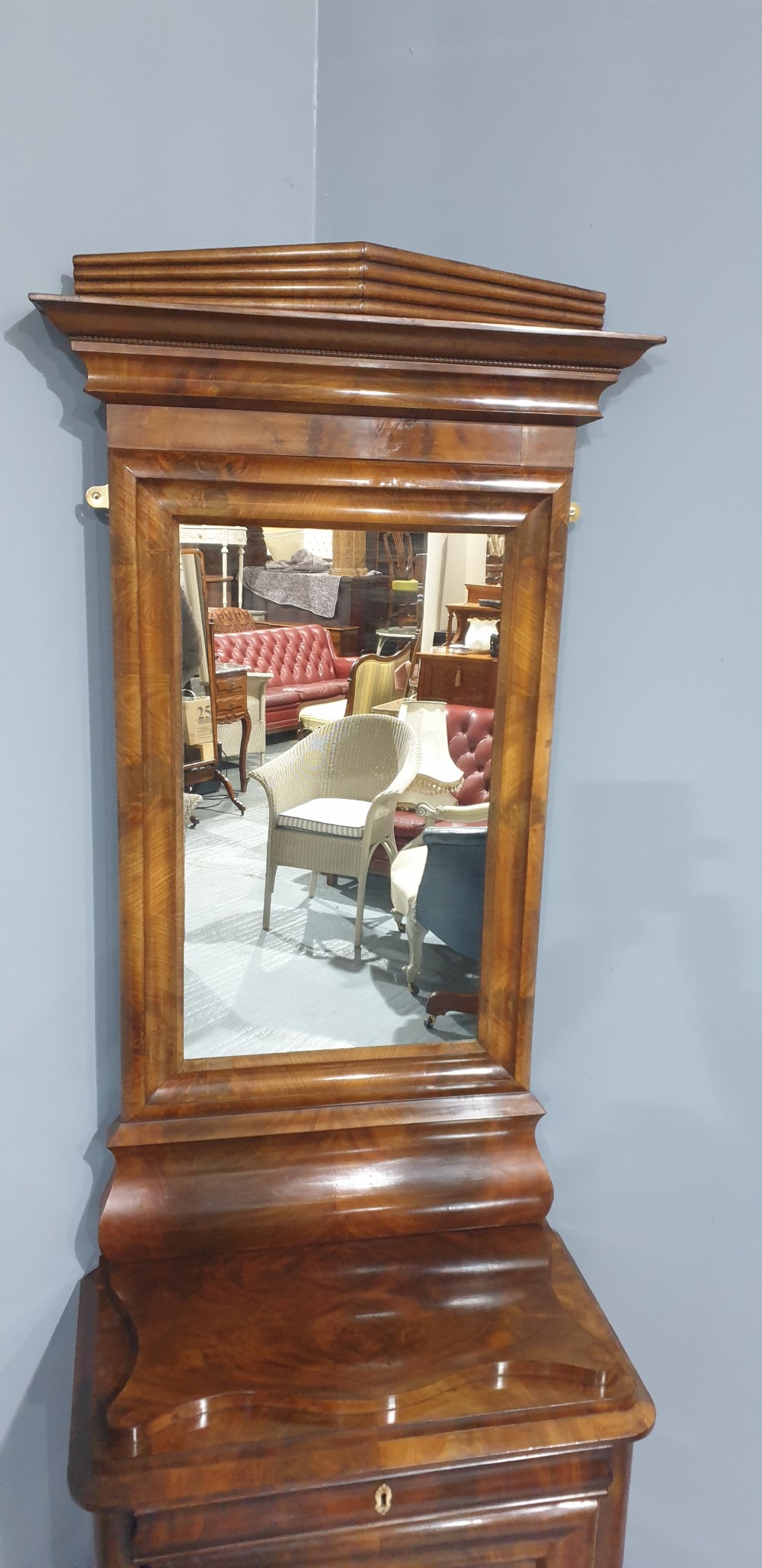 An antique Biedermeier tall warm brown veneered console cabinet featuring a fitted rectangular mirror above a single drawer and panelled cupboard base. View VIII